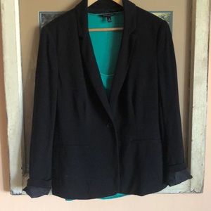 Black, hip length slouch blazer.